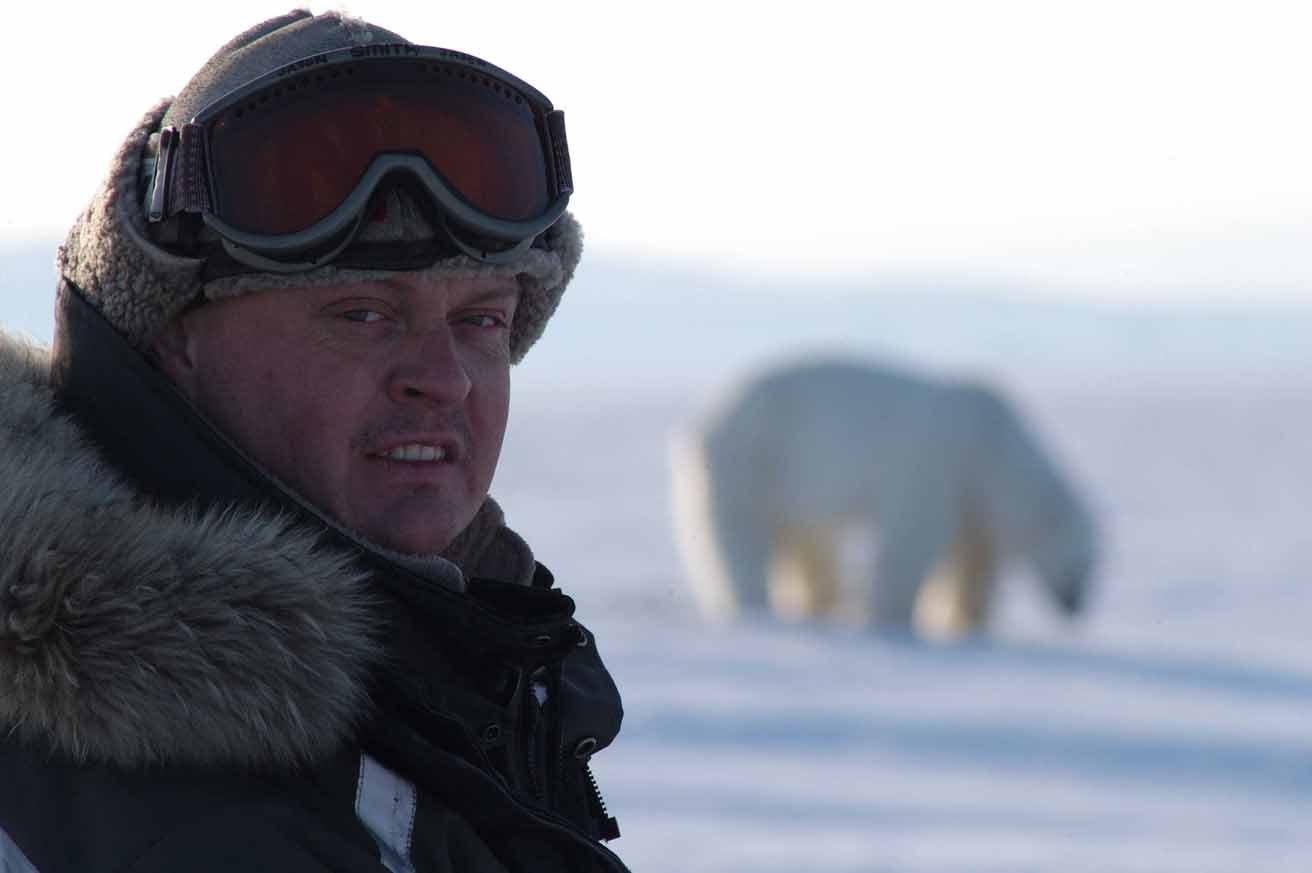 Jason Roberts presenting to camera with a Polar Bear as backdrop!