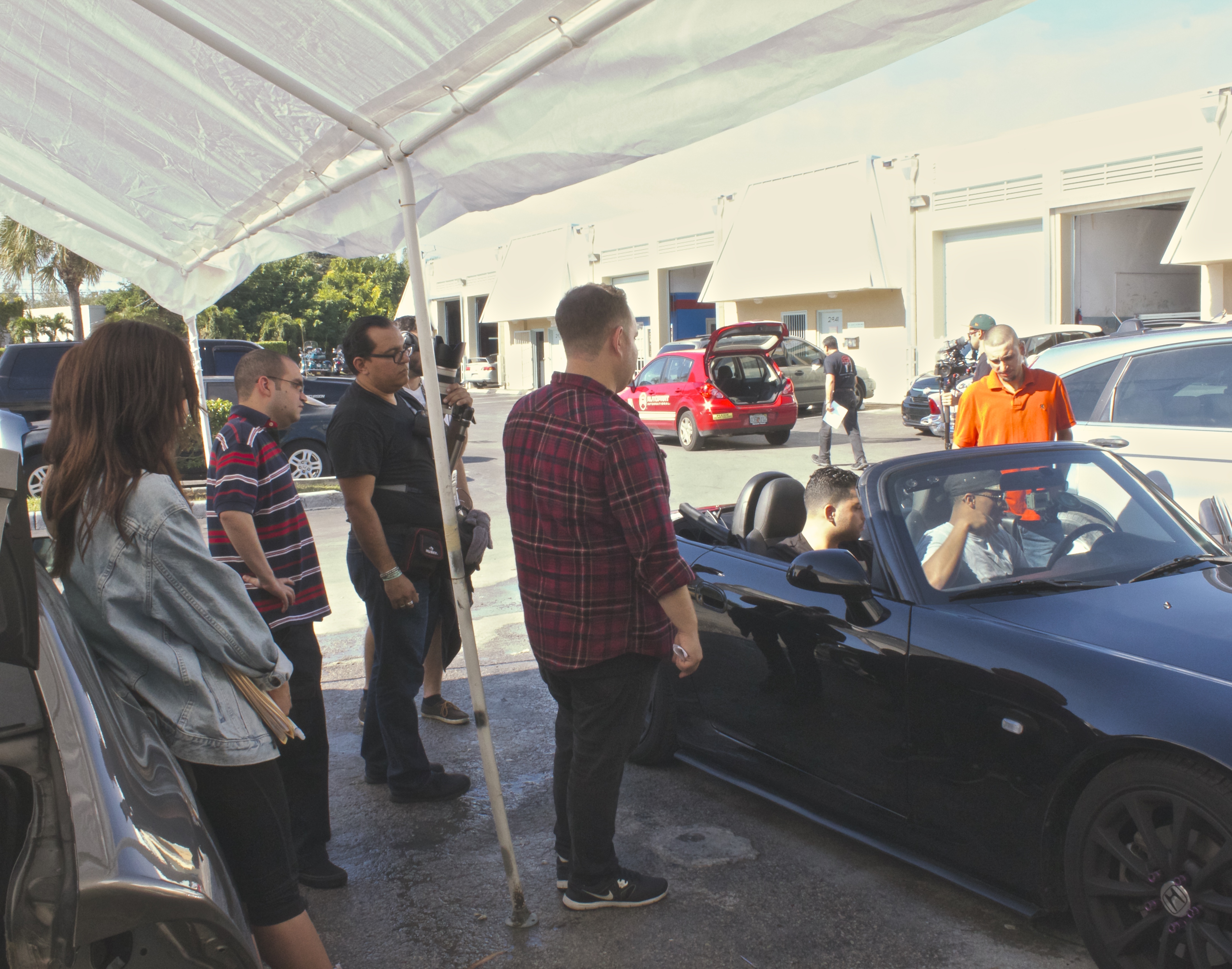 Filmmaker Eddie Mariano directs Alberto Delgado, Jr. as picture car gets ready.