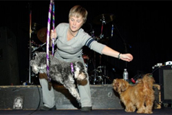 Beverly Ulbrich, The Pooch Coach, performing tricks on stage with her dog for charity.