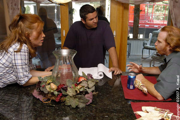 Jennifer Butler Wiener(Michael's Mother) and Courtney Gains (Michael's Father) discuss a scene with director Amel Figueroa on set of The Quiet Ones