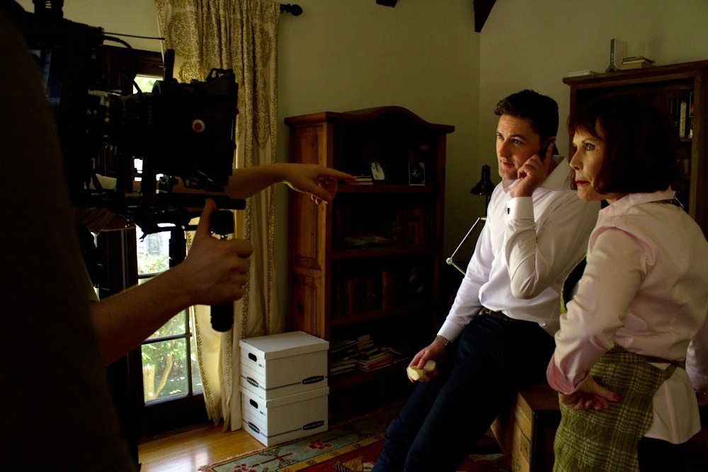 Emmett Skilton with Mae Quiggly on set of Bella