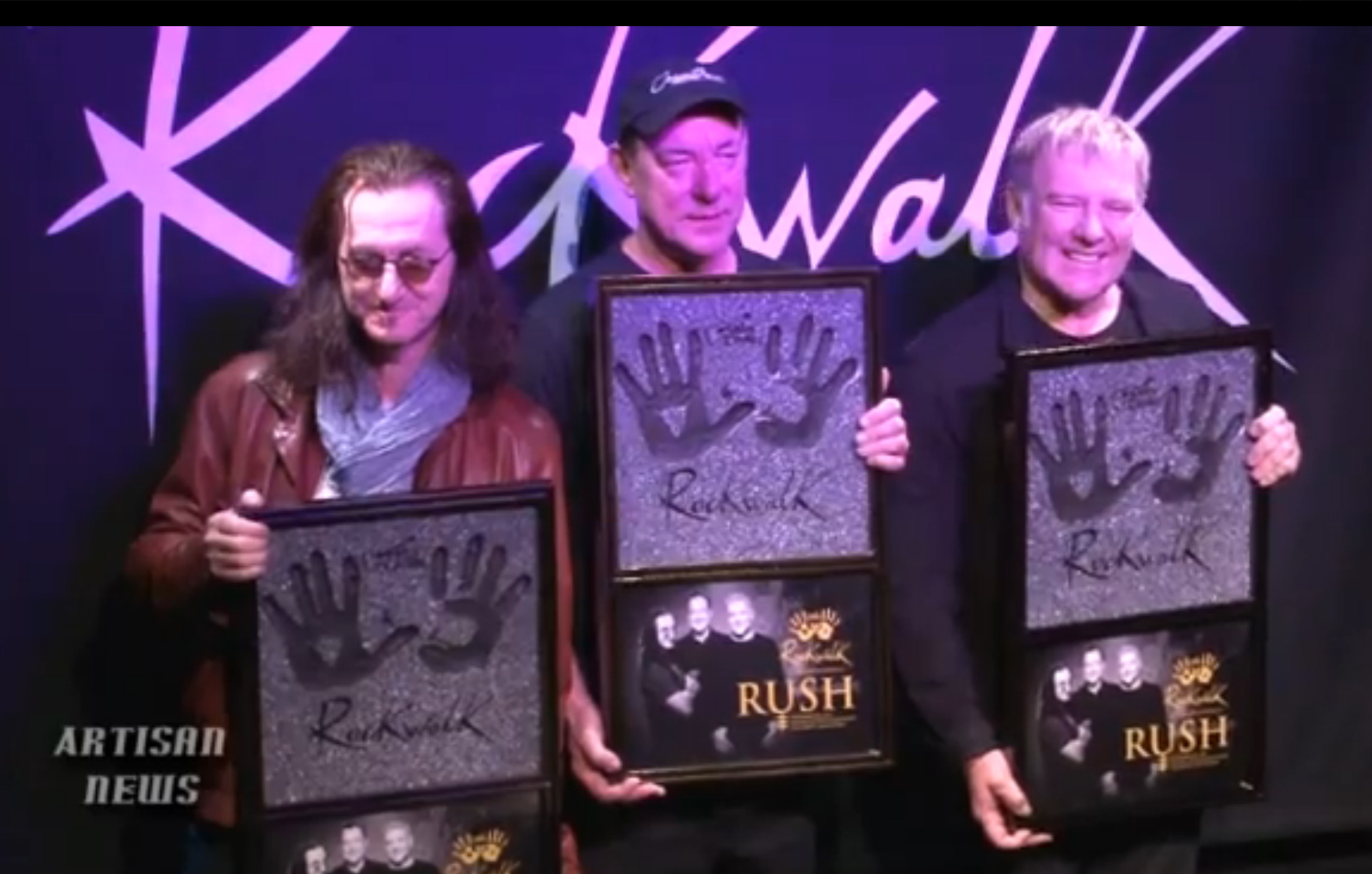 Iconic Rock Band Rush holding commemorative plaques at their induction into the RockWalk Hall of Fame. Plaques Designed and fabricated by Meredith Day/Dreamland-3D.com