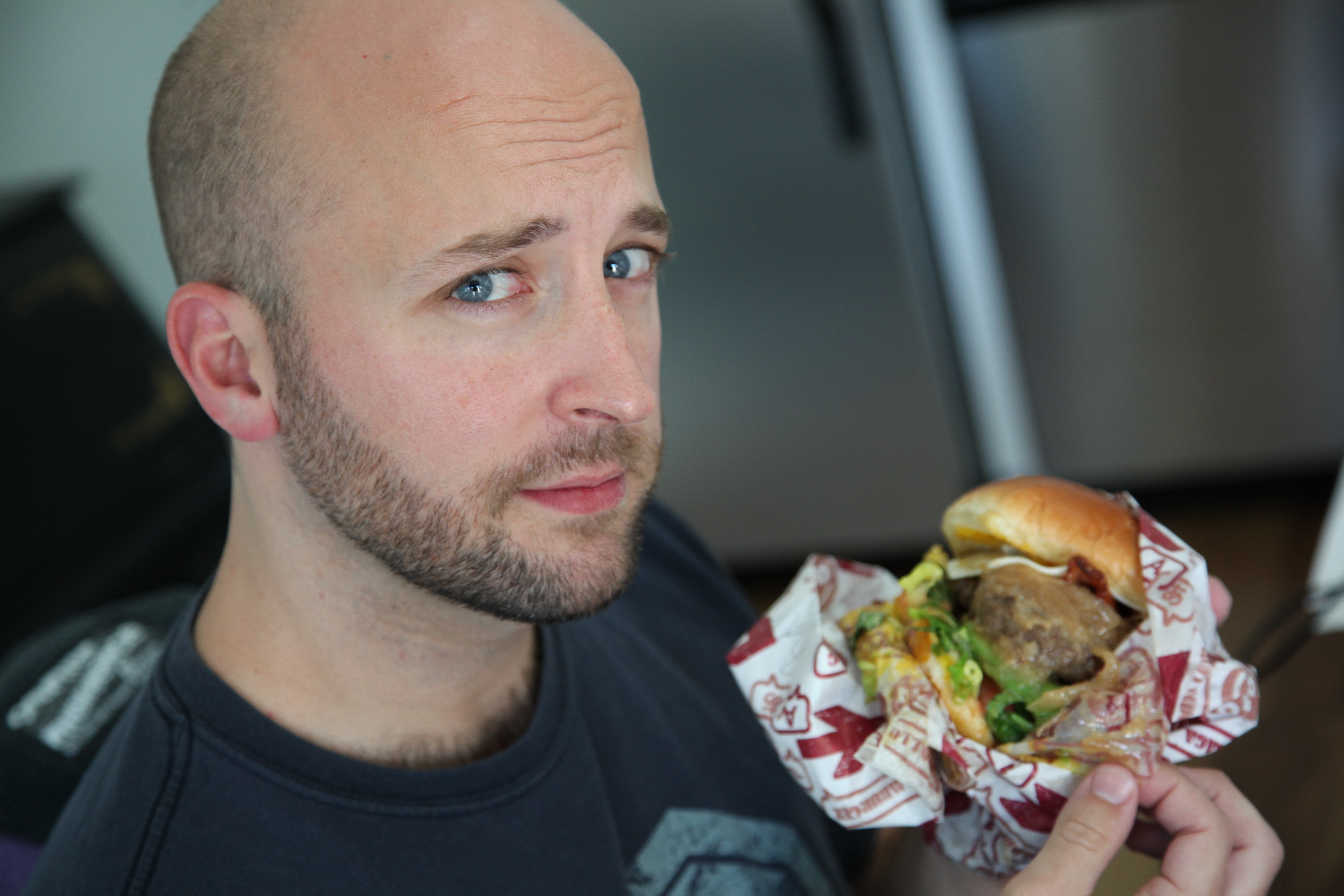 Ben Waters, seen here in his natural habitat - holding a cheeseburger.