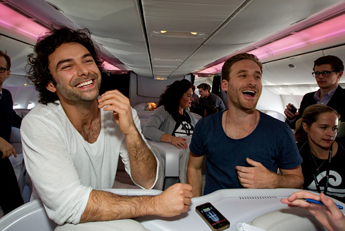 Aidan Turner and Dean O'Gorman being interviewed by the media on board Air New Zealand special The Hobbit air plane during flight to world premiere of The Hobbit: An Unexpected Journey.