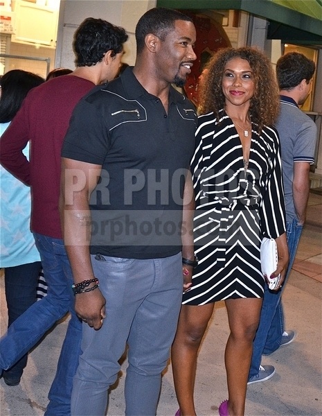 Actor Michael Jai White and girlfriend, actress Gillian Iliana Waters holding hands, leaving Elysium premiere in Westwood.