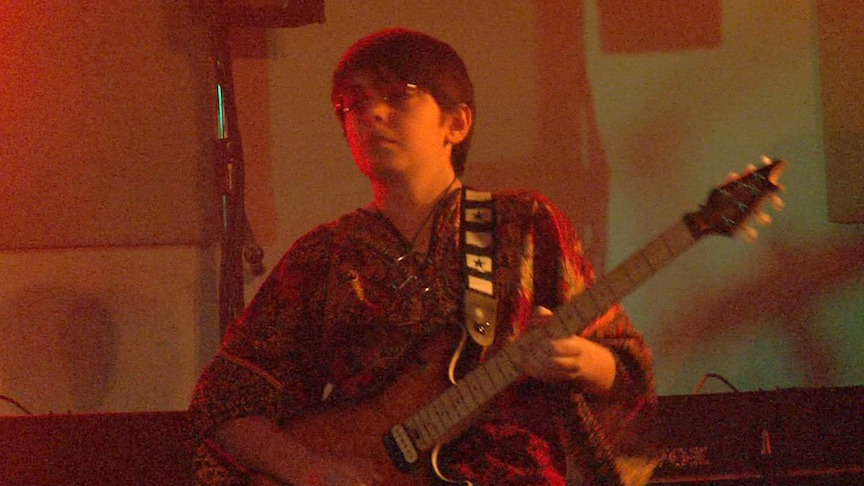 Evan Materne on lead guitar at The Beatles tribute show