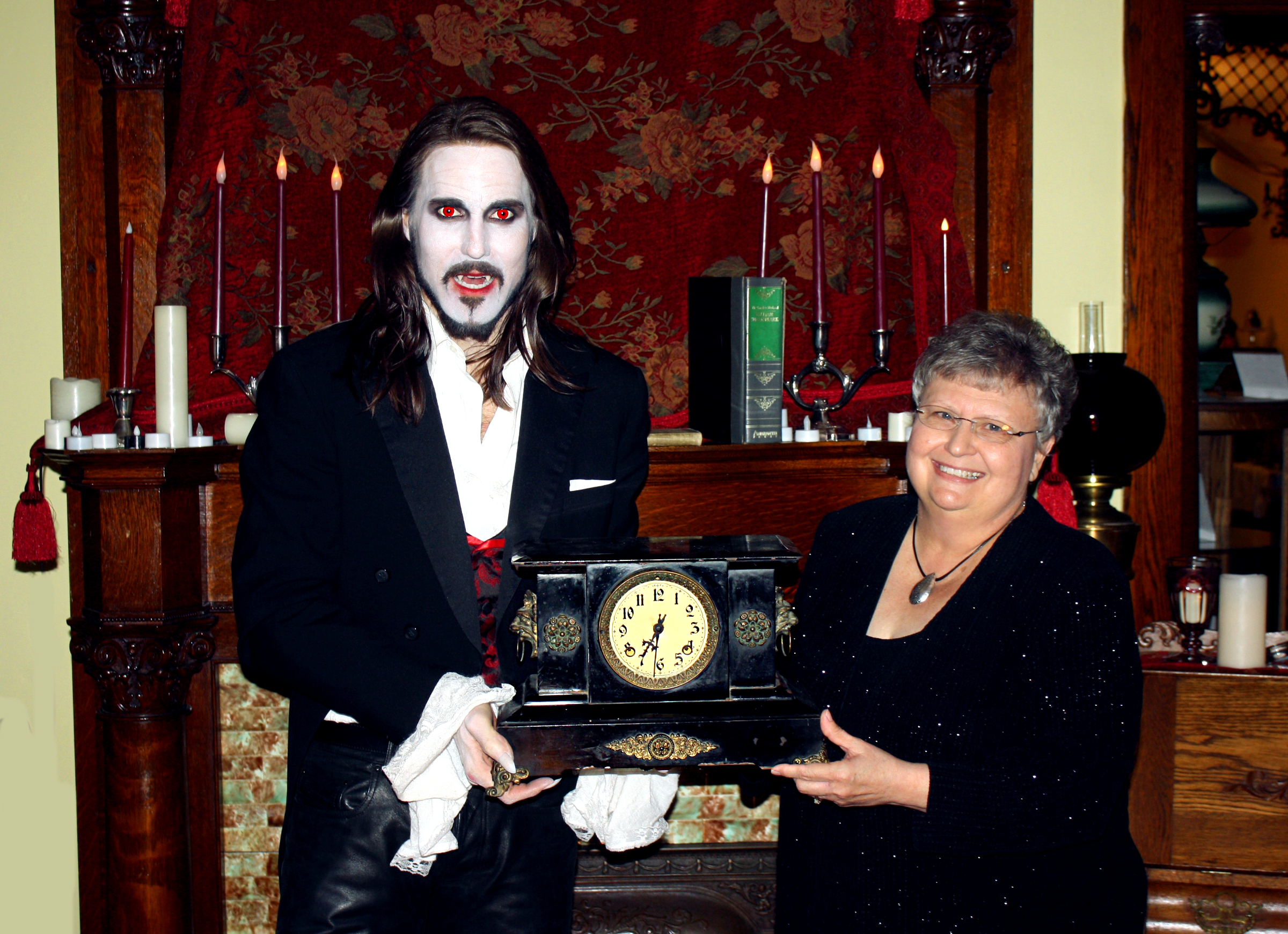 MATT WIGGINS (in DRACULA make-up) is presented a historic mantel clock from the a Board Member for the Randleman House historic home in Carlise, IA, which was selected as one of the locations used for Matt's hit live production of Bram Stokers DRACULA.
