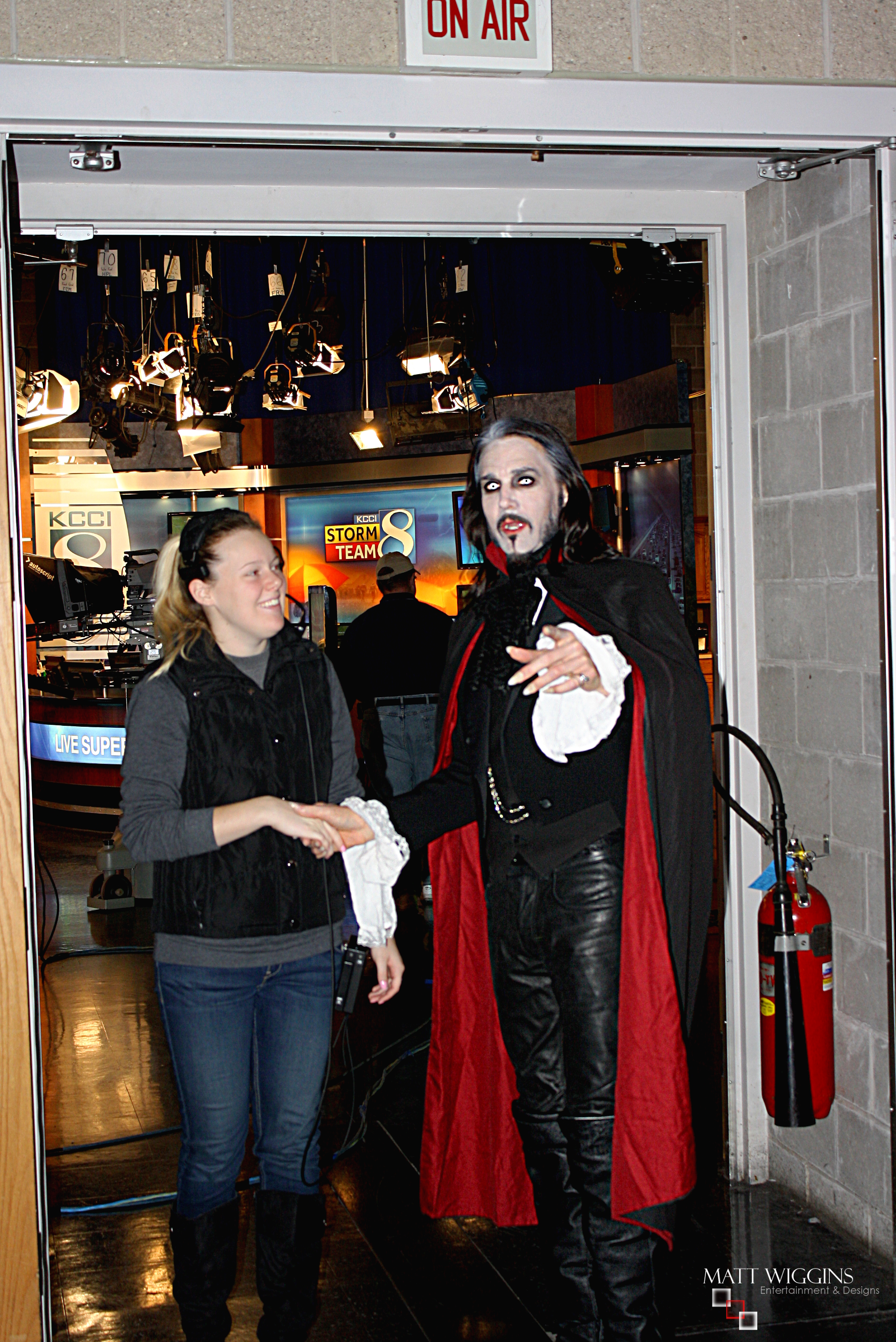 Matt Wiggins arriving for an television interview in full Dracula as he is greeted by a member of the News CH 8 studio production team in Des Moines in October 2013.