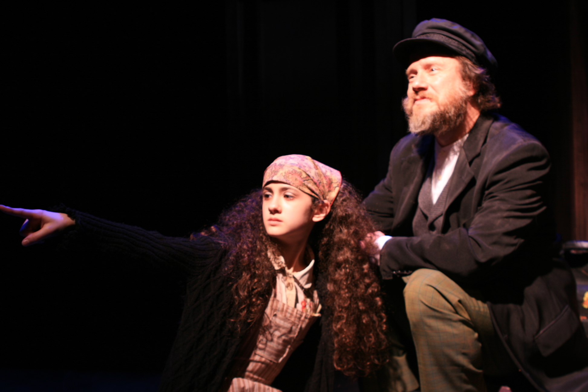 Leah Rose Orleans, as the Little Girl, points the way to America in Porchlight Music Theatre's RAGTIME.