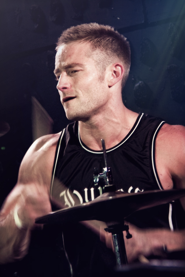 Beau DeSilva playing drums for South Bay punk band, False Alliance.