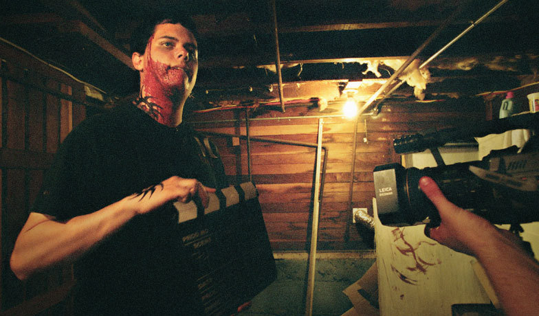 Devin Fearn helps out with the clapboard during his bloody fight scene in the basement.