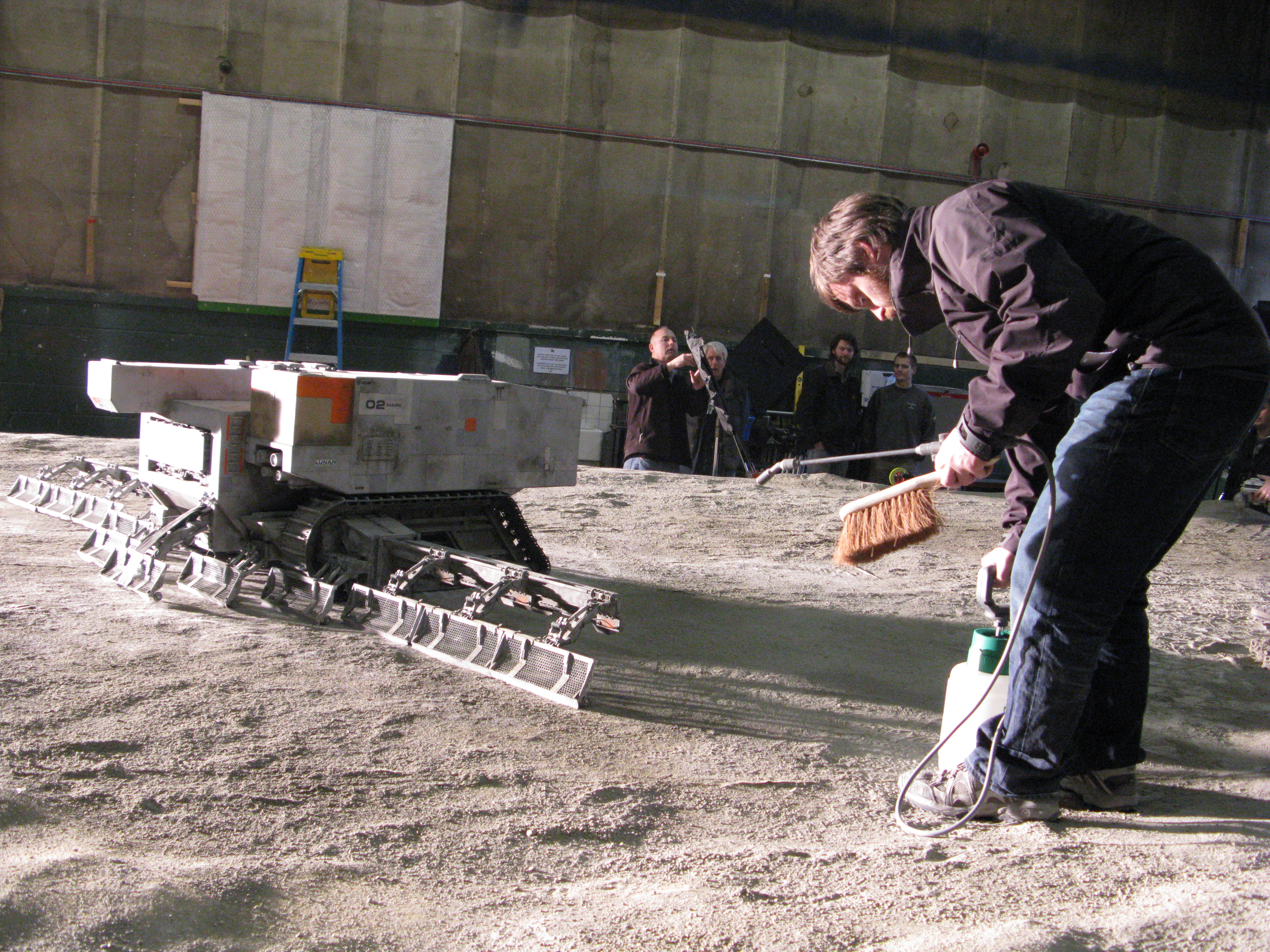 Resetting the 1/12th scale lunar surface for a shot with a harvester vehicle during the model miniature shoot for 