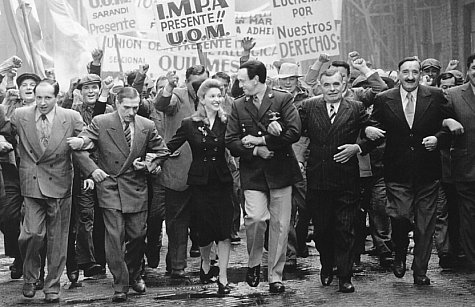 From poor beginnings Eva (Madonna, center left) marries rising political star Juan Peron (Jonathan Pryce, center right) and becomes the most powerful woman in the country.