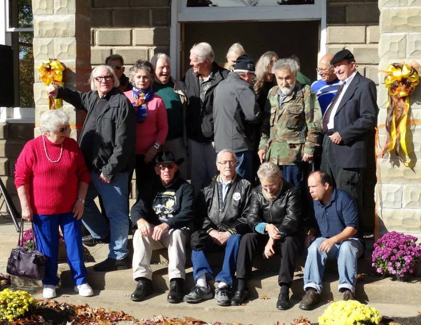 A candid group shot taken of many of the cast members from George Romero's original 'living dead' trilogy; immediately following the Evans City Cemetery Chapel Re-Dedication Ceremony on October 11, 2014.