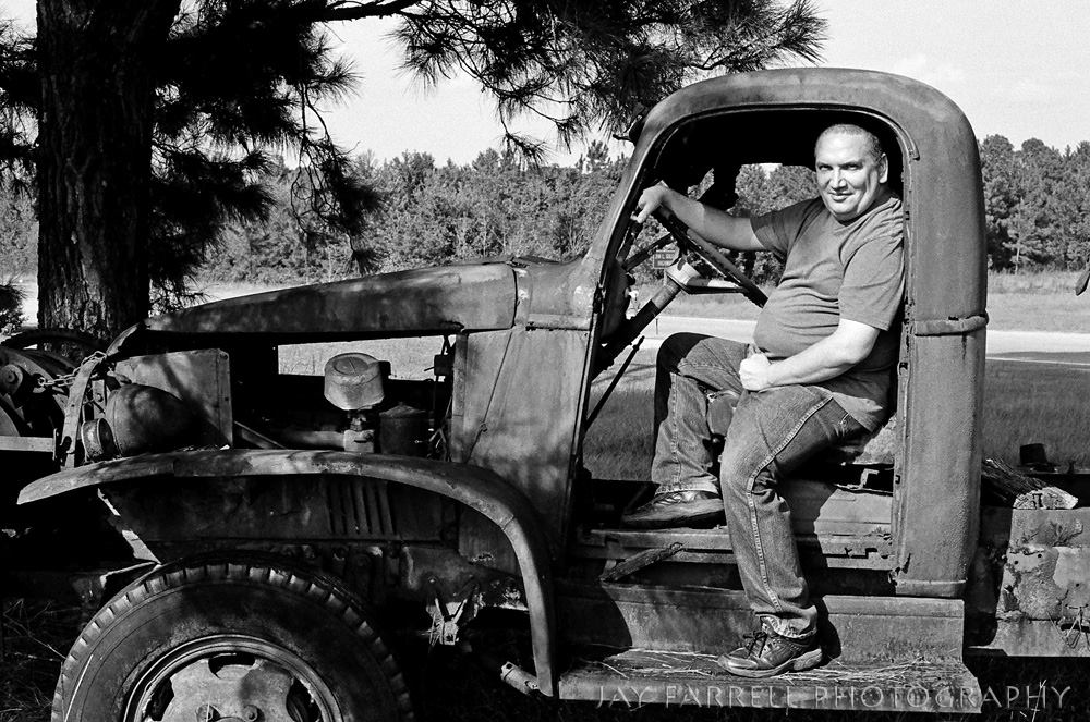 Casual photo of James Magnum Cook sitting in an old truck on his way to St. Simons Island, Georgia.
