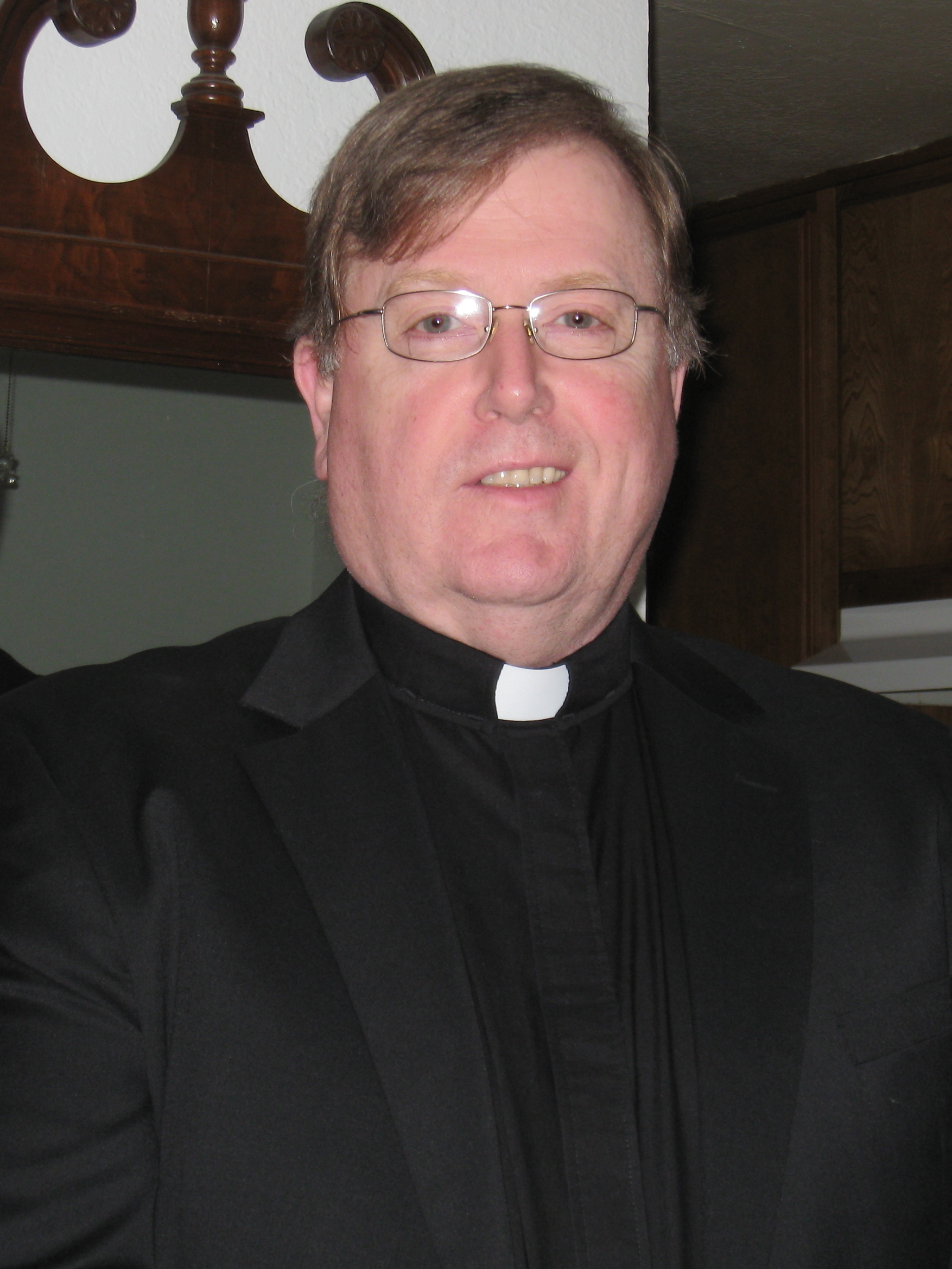 Thomas F. Evans as Fr. Ron.
