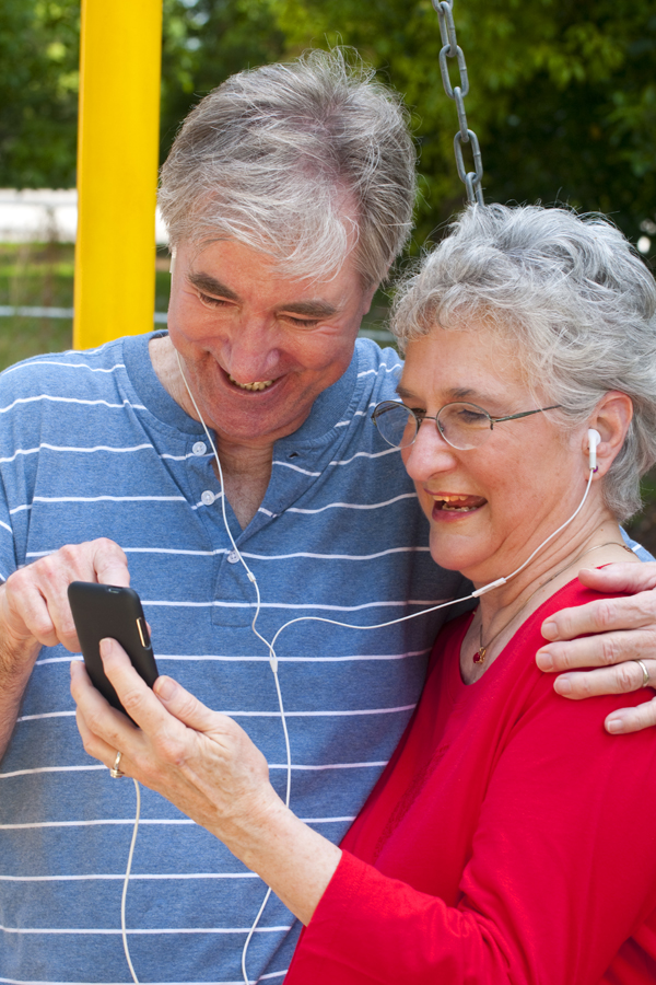 Senior couple using Ipod.