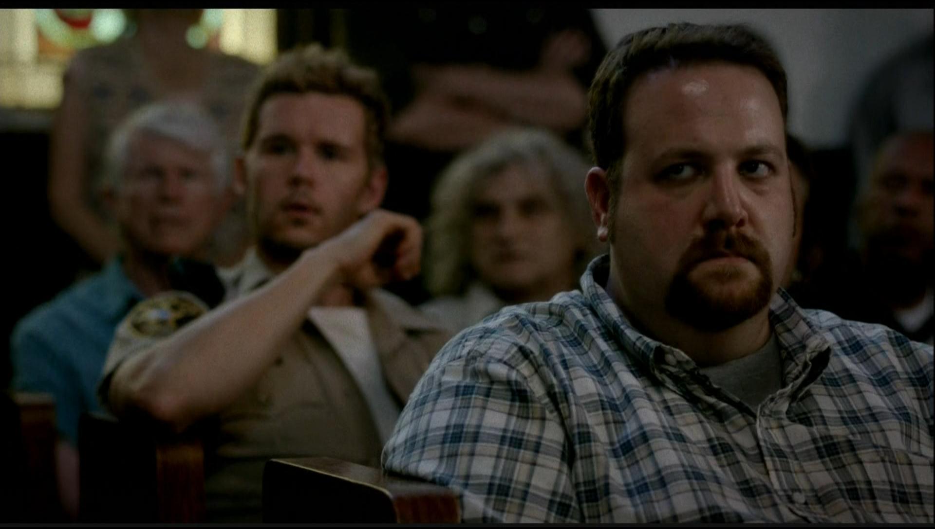 Jason Stackhouse (Ryan Kwanten) and an angry Bon Temps townsperson (Ben Zelevansky) attend a church meeting on 