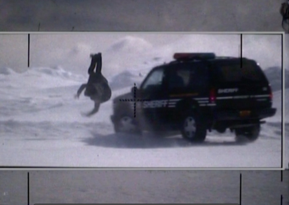 Sean flying off the roof of a braking car on 