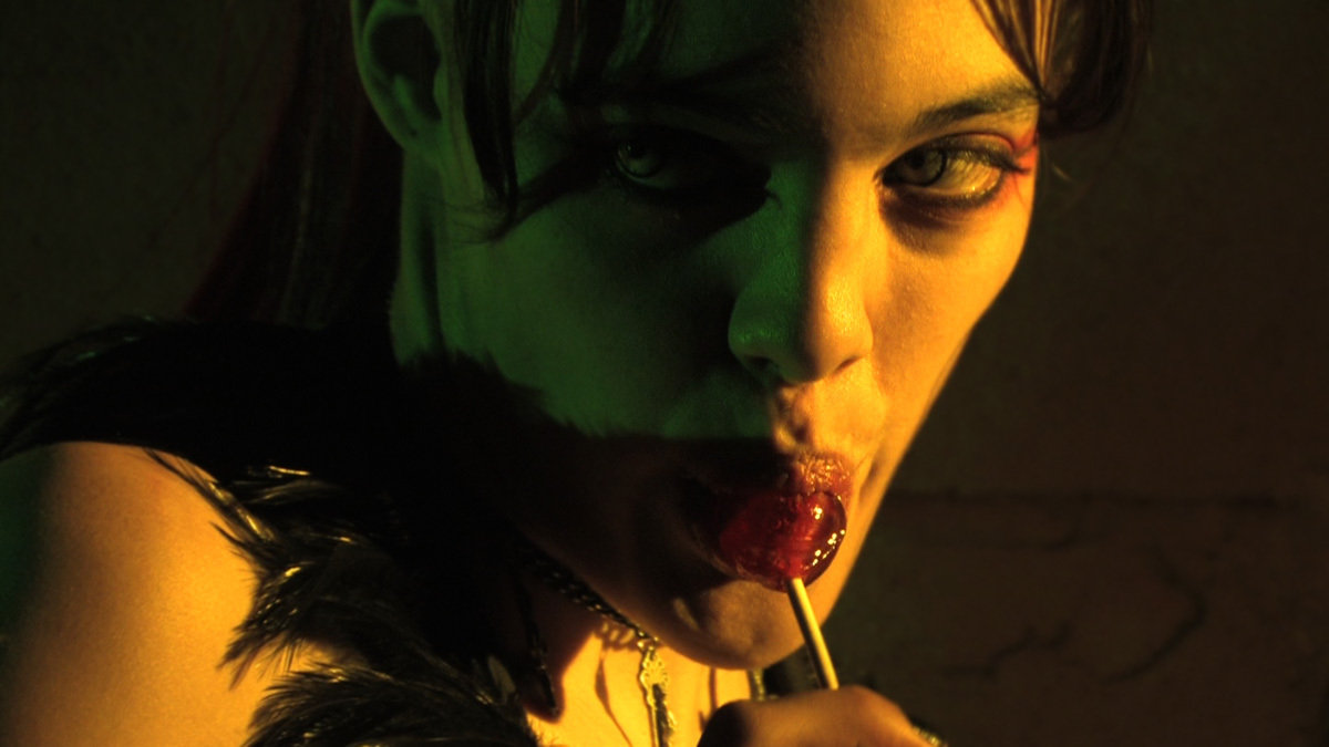 Lolli (Krystal Freeman) seductively enjoys a taste of her namesake.