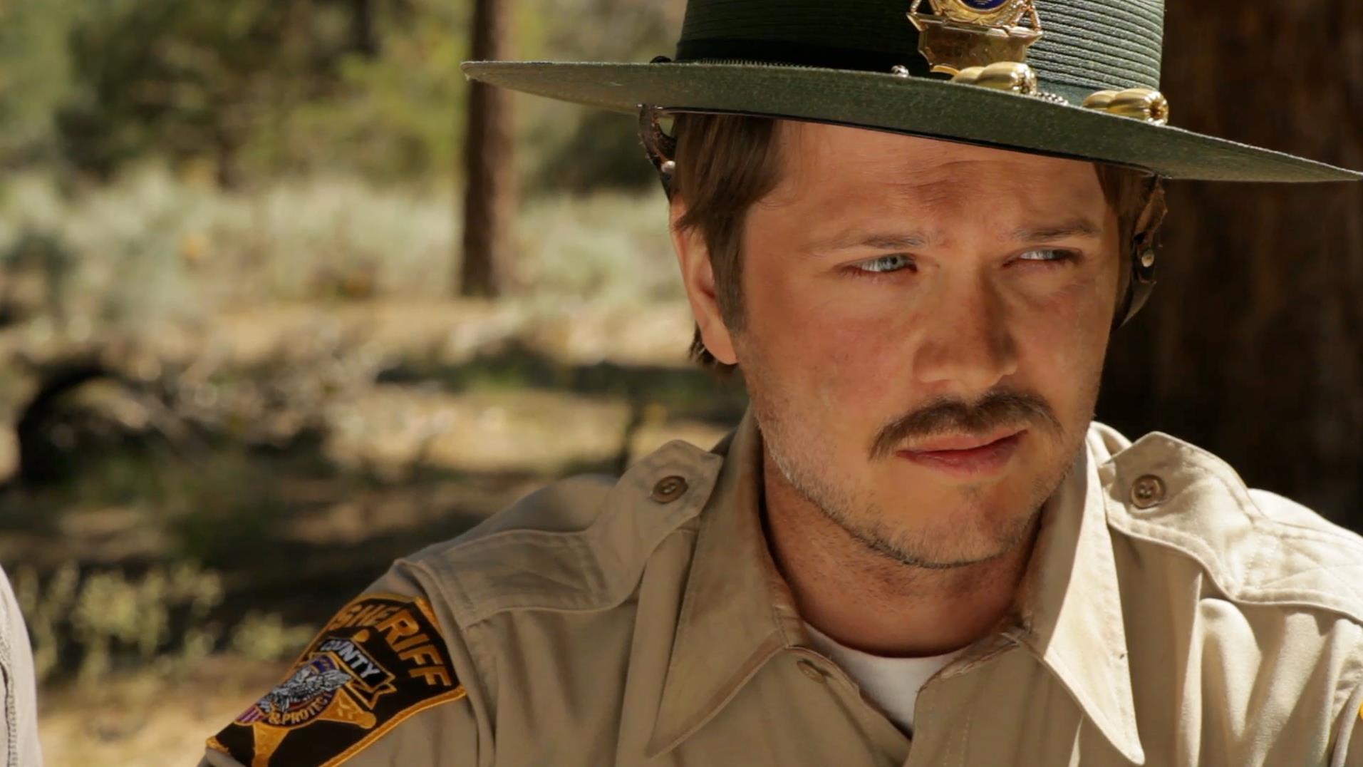 Richard C. Jones as Officer Hopkins in Dragon Day
