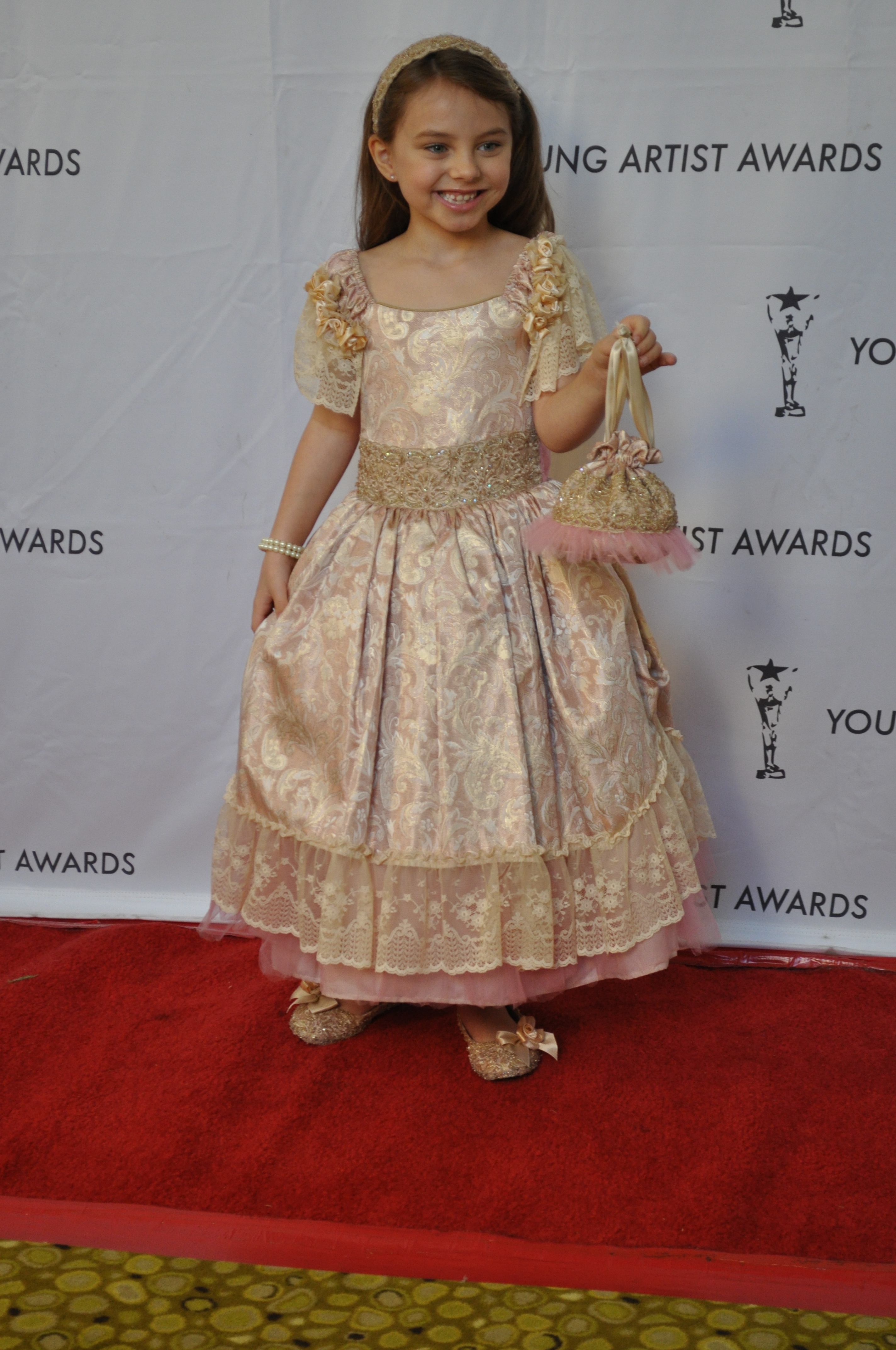 Caitlin Carmichael wearing Wanda Beauchamp dress and accessories on red carpet for Young Artist Awards March 2011