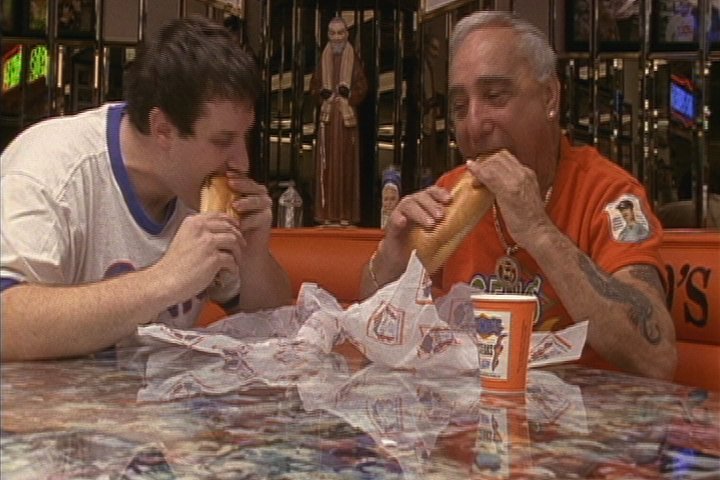 Director Ben Daniels and Geno's Owner Joey Vento share a bite together.