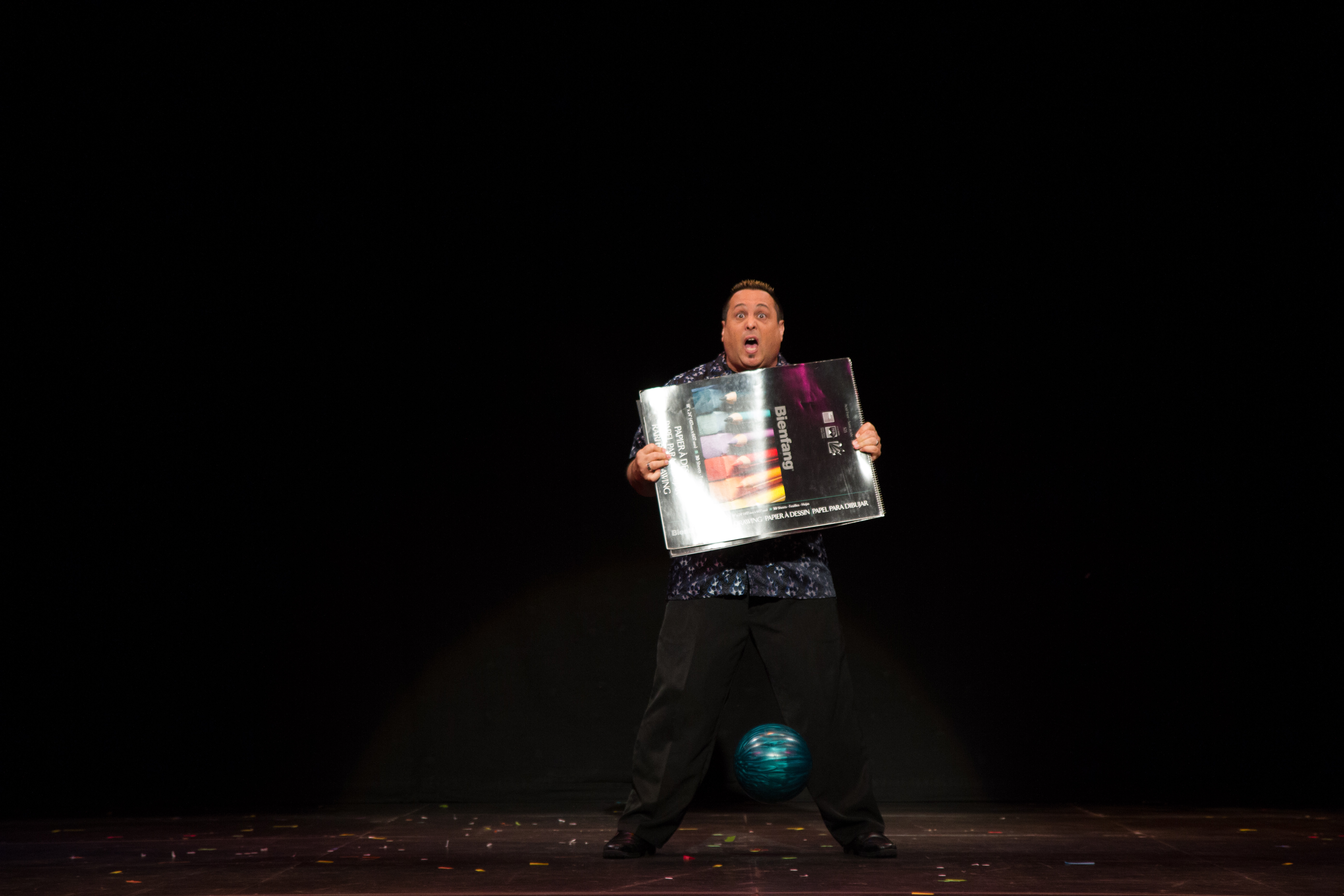 Michael C. DeSchalit making a bowling bowl drop out of nowhere during the Stars of Magic 26 anniversary show.