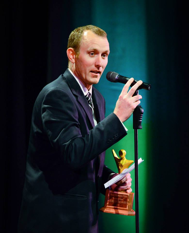 Adam White giving acceptance speech for Best Feature Film award for Inspired Guns