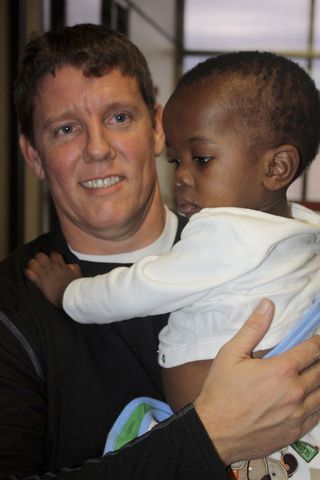 Lake Sherwood resident Chris Morrow with a child, Benicio, who was airlifted out of Haiti a few days ago and adopted by Morrow's friend and business partner who lives in Visalia, Calif.