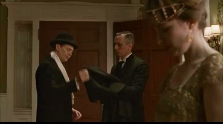 Handing Nucky Thompson (Steve Buscemi) his coat on the Season 3 premiere of Boardwalk Empire, Kelly Karavites, the new Thompson house butler.