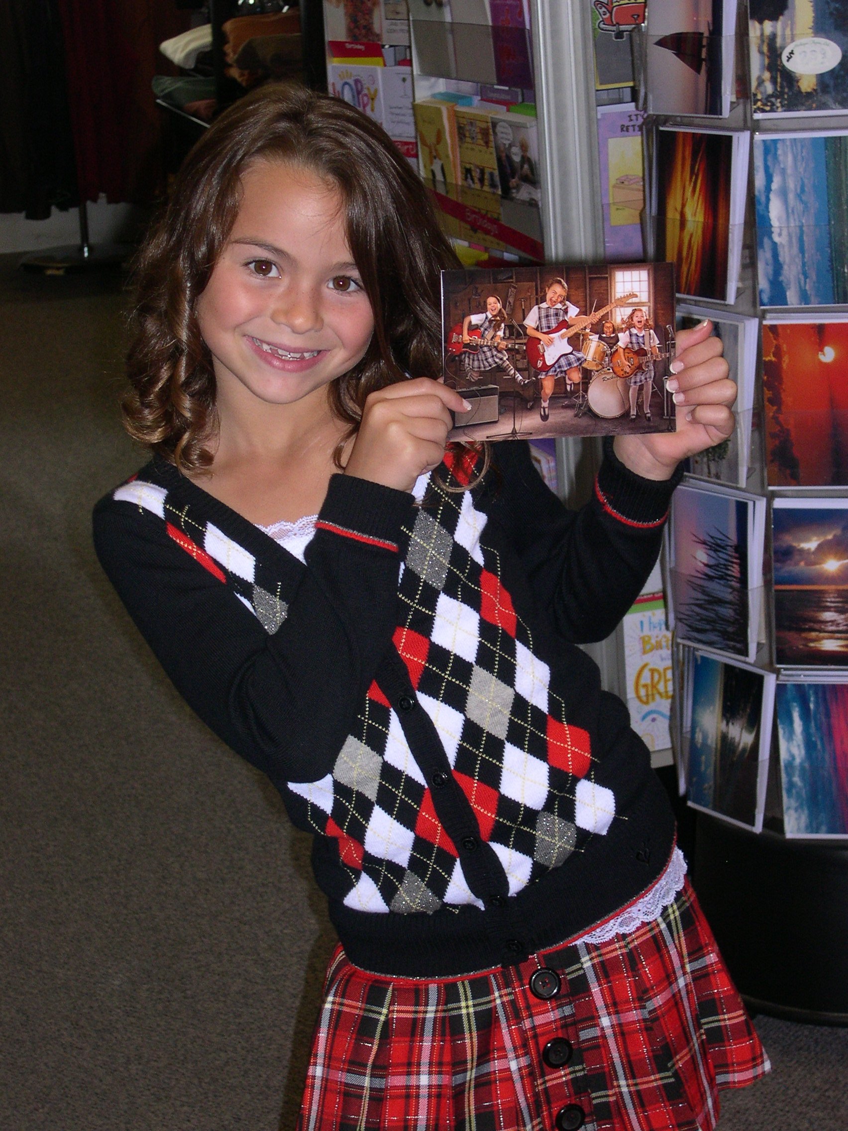 Jacquelyn holding a Greeting card by Avanti that she modeled for..She is girl jumping with braids in front..