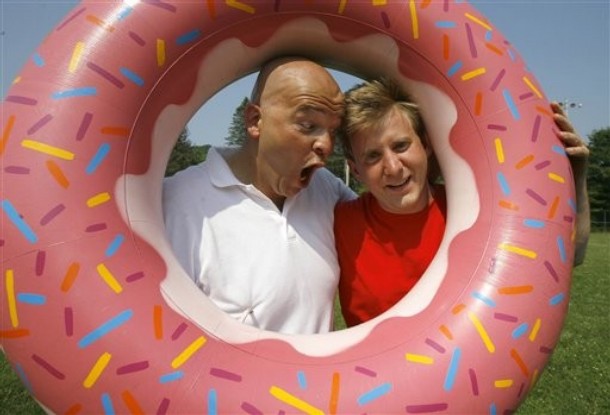 Tim Kavanagh, left, as Homer Simpson, and Brock Rutter as Bart Simpson, pose inside a fake doughnut in Springfield, Vt., Tuesday, June 19, 2007.