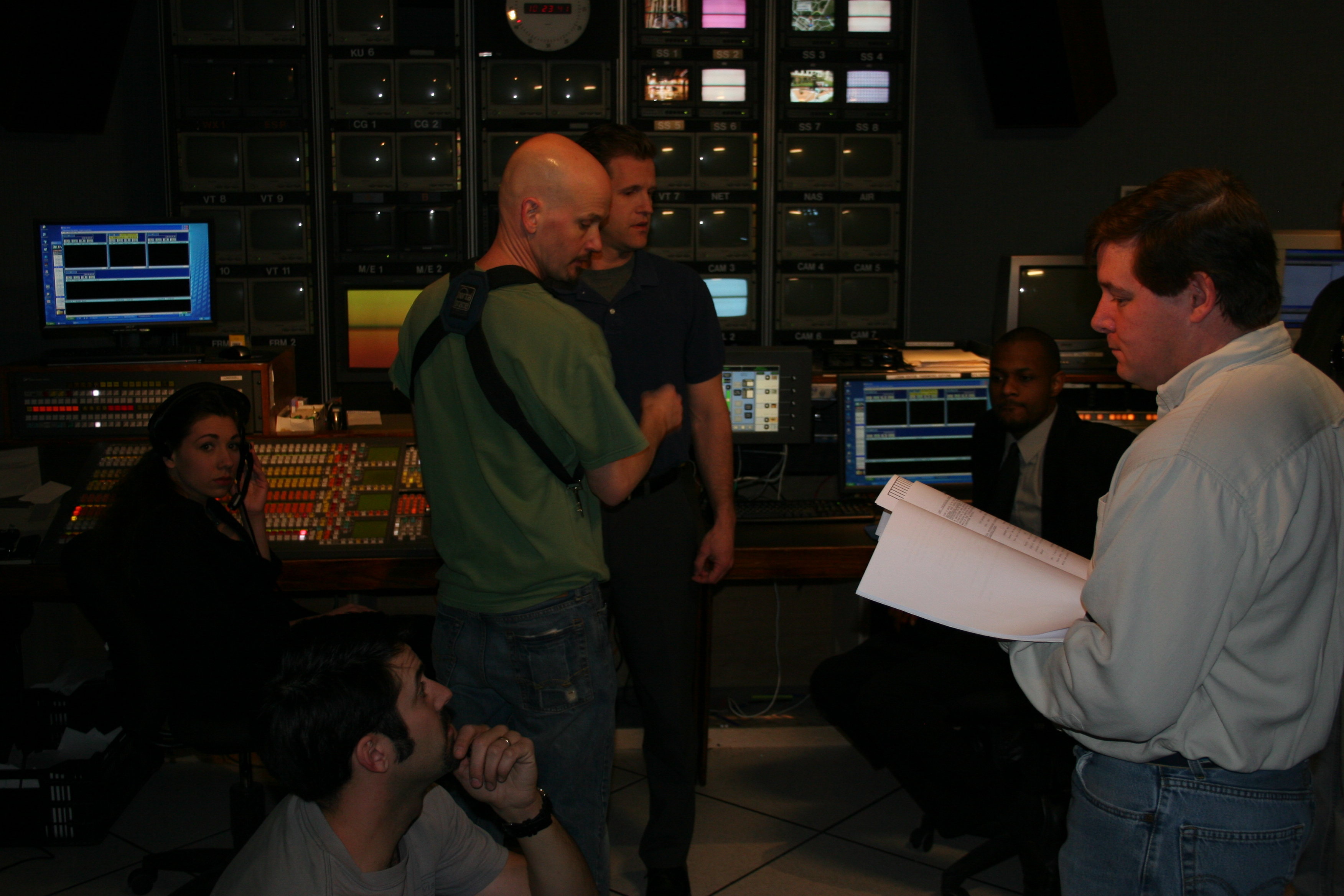 Associate Director Richard Lesko, right,prepares for the control room scene with cast and crew.