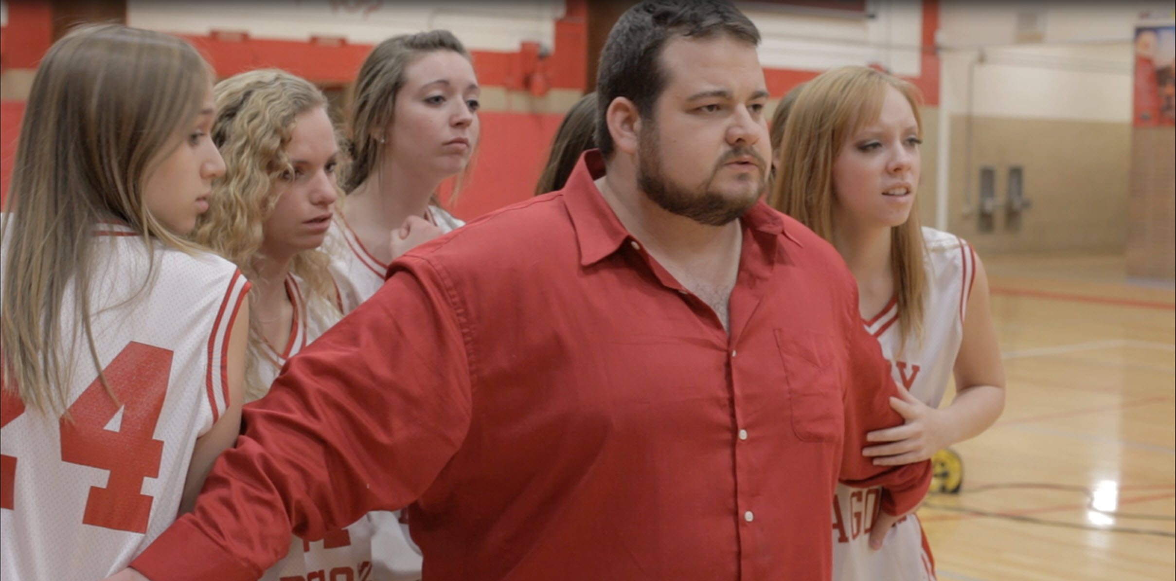 A still from Monsters on Main Street featuring Brad Leo Lyon as Coach Paul Blake.
