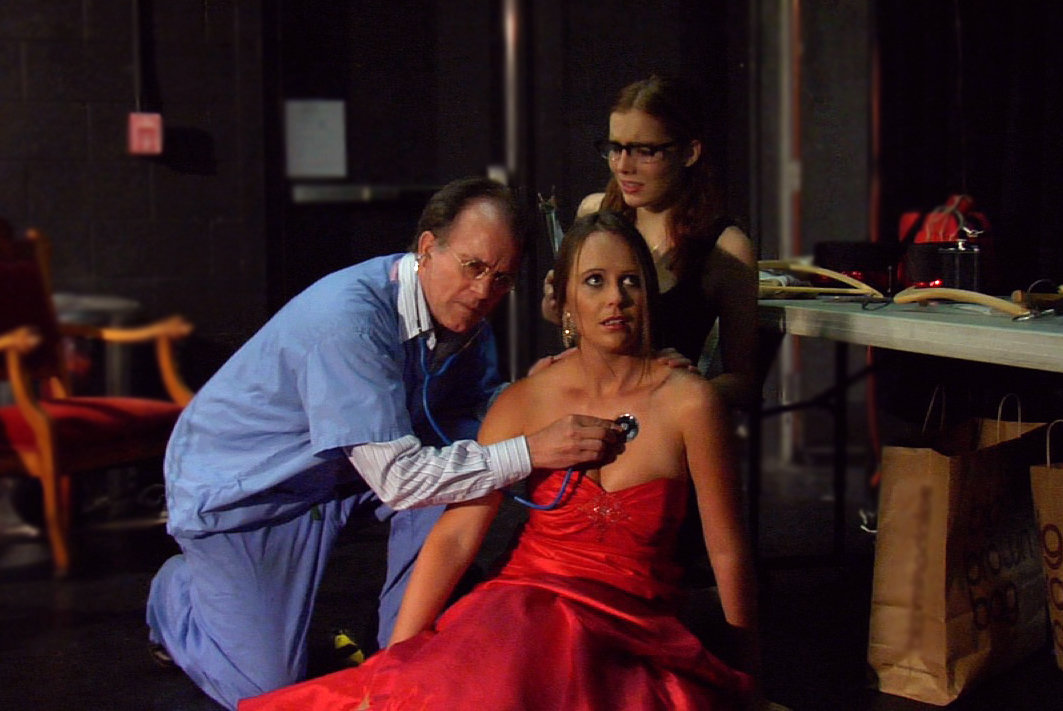 Vanessa is checked by the Doctor as assistant Valerie looks on