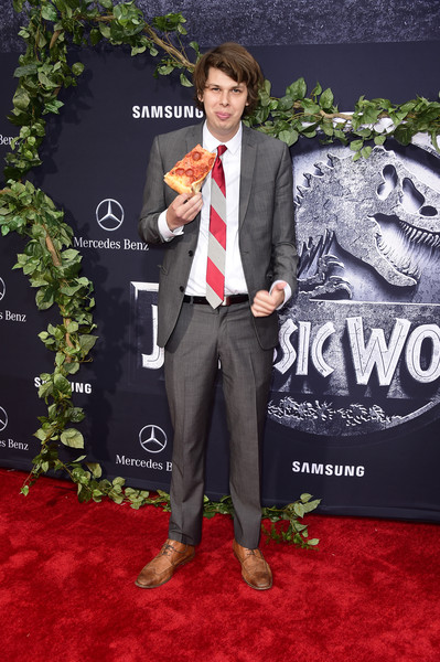 Matty Cardarople enjoying a slice of pizza on the red carpet of the world premiere of Jurassic World.