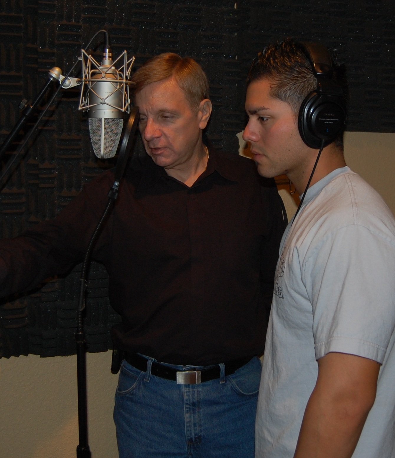 Kim Richards with Nick Cardenas, oldest son of Renegade drummer and vocalist Luis Cardenas. Young Nick was in the studio contributing both vocal and drum skills for his father's upcoming solo offering. Richards, who is producing, is seen here giving Nick some guidance during a recent recording session.