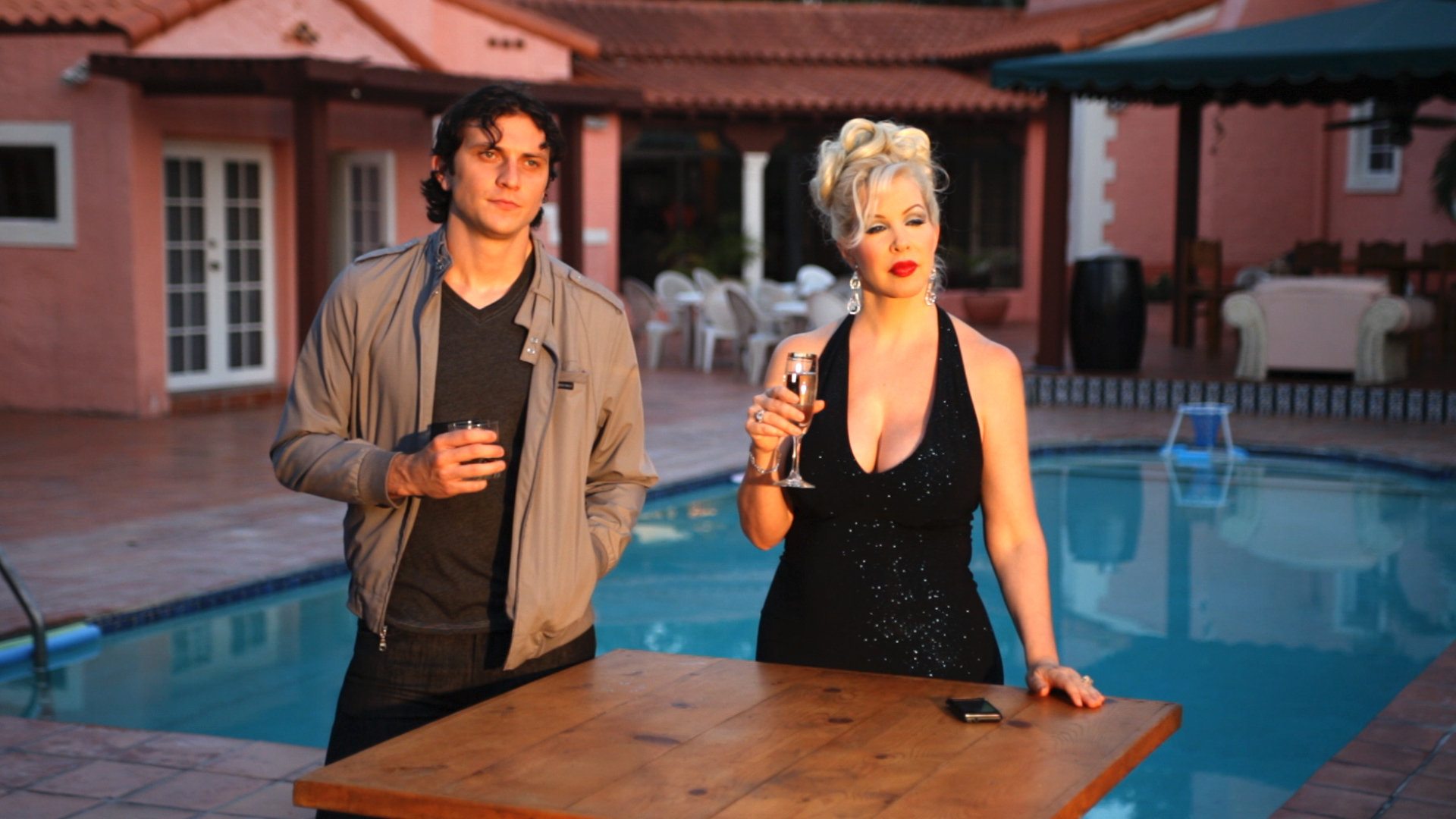 James (Joseph Myers) and Lana (Bambi La Fleur) having drinks at Lana's oceanfront home.