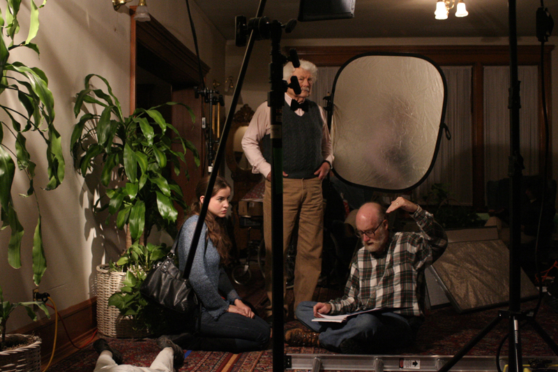 Director Hank Isaac discusses a scene with actors Tara Hanson and Stan Claussen.