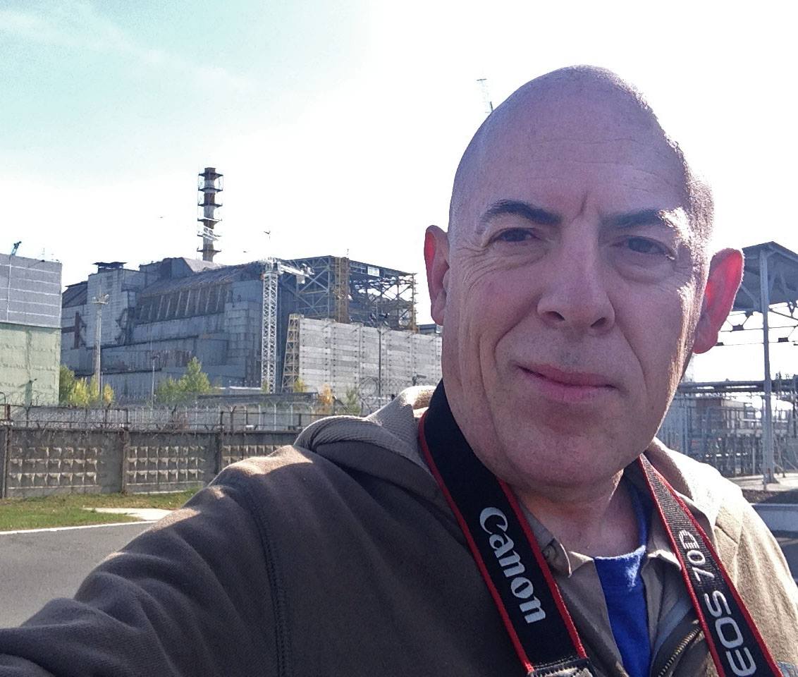 Glenn Campbell at the Chernobyl Nuclear Power plant in October 2014. The building behind him is the reactor where the meltdown occurred.
