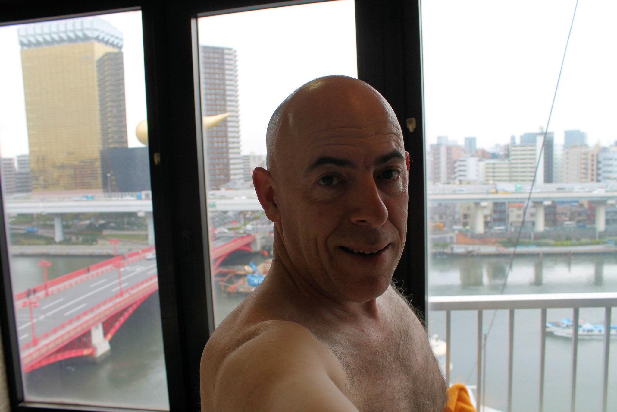 Naked in a glass-enclosed rooftop bathhouse in front of all of Tokyo. This is the roof of a capsule hotel where Glenn spent the night in a tiny compartment only 8 feet long and 4 feet high.