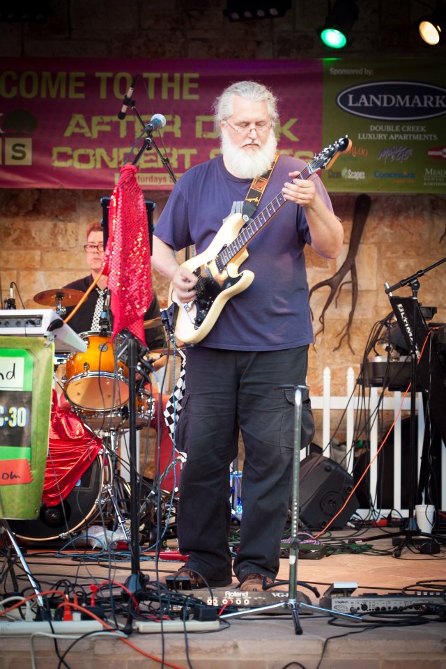 Mark Connelly Wilson plays guitar at an outdoor concert with his cover band Airwave 80s.
