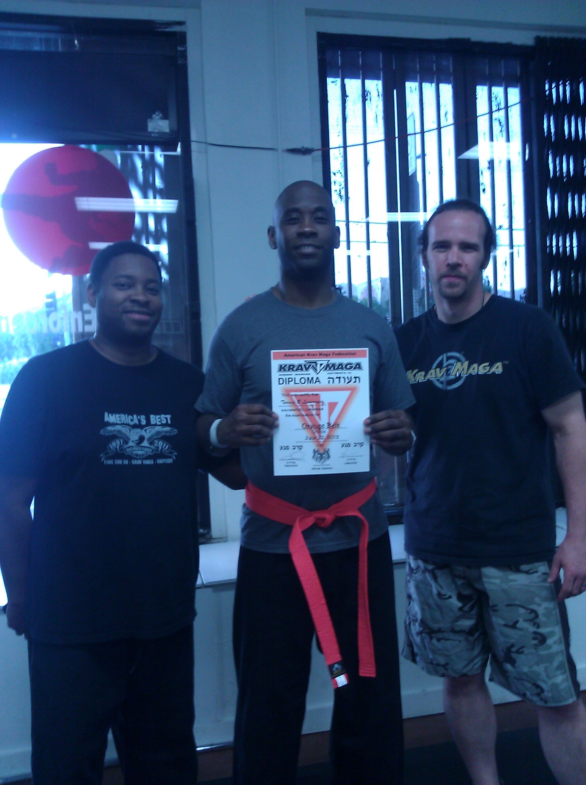 Me and Instructor Tony Hardy and Master Nathan Carlen, receiving my Orange Belt
