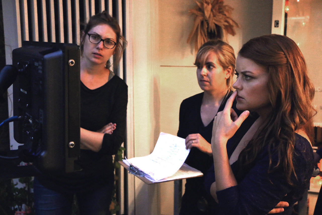Director Sarah Phillips watches the monitor with producer Laetitia Leon.