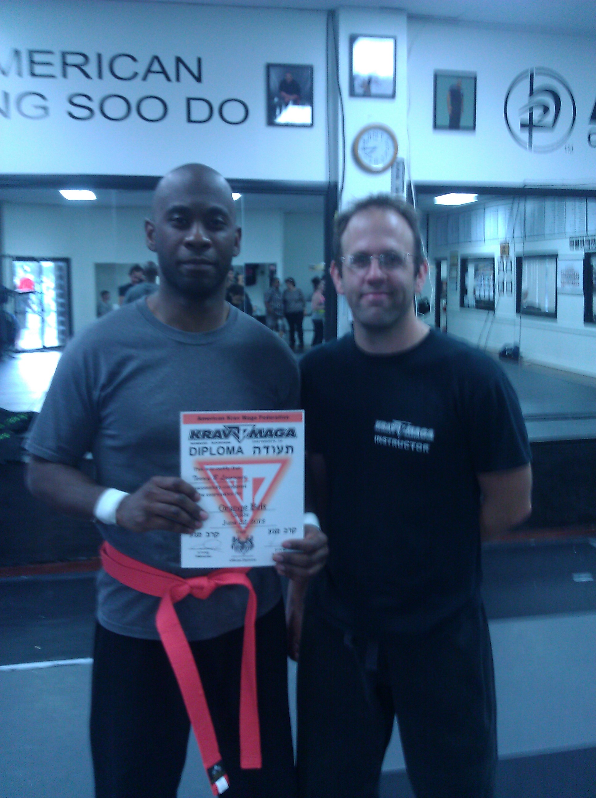 Me and Instructor Crhis Crouch, receiving my Orange Belt
