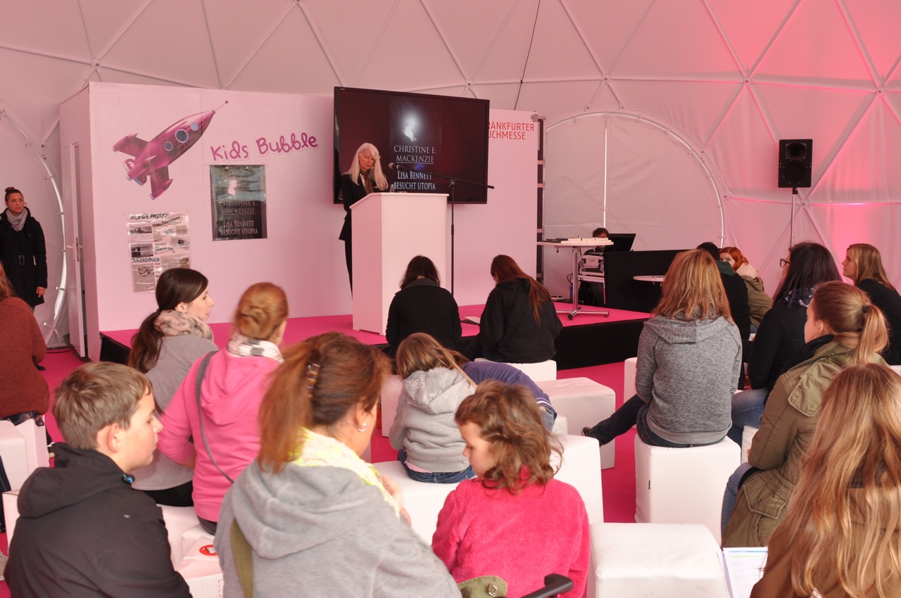 FRANKFURT INTERNATIONAL BOOKFAIR read a passage, where a little girl dreams of becoming an astronaut and built a pink cardboard rocket in her backyard. Suddenly I realized, there was an actual pink rocket on the wall behind me...