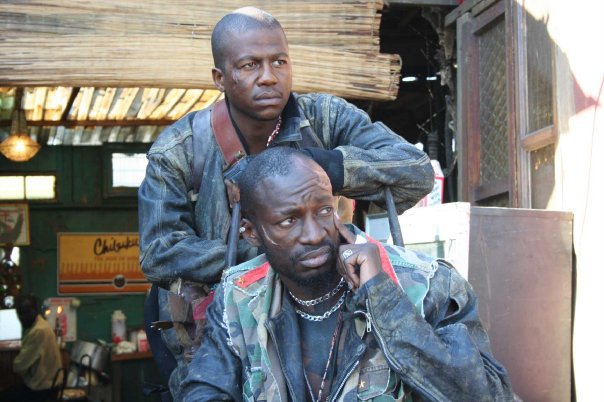 Eugene Khumbanyiwa (seated) as Obesandjo & Siyabonga Radebe on set of the four time Oscar nominated movie District 9(2008)