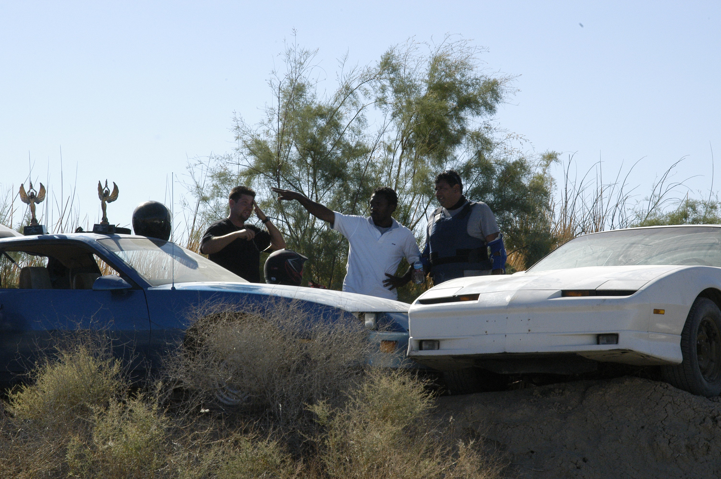 Director Dee Asaah discusses a pivotal stunt scene with Stunt Coordinator Gary Robert on the set of Blood Sun Town.