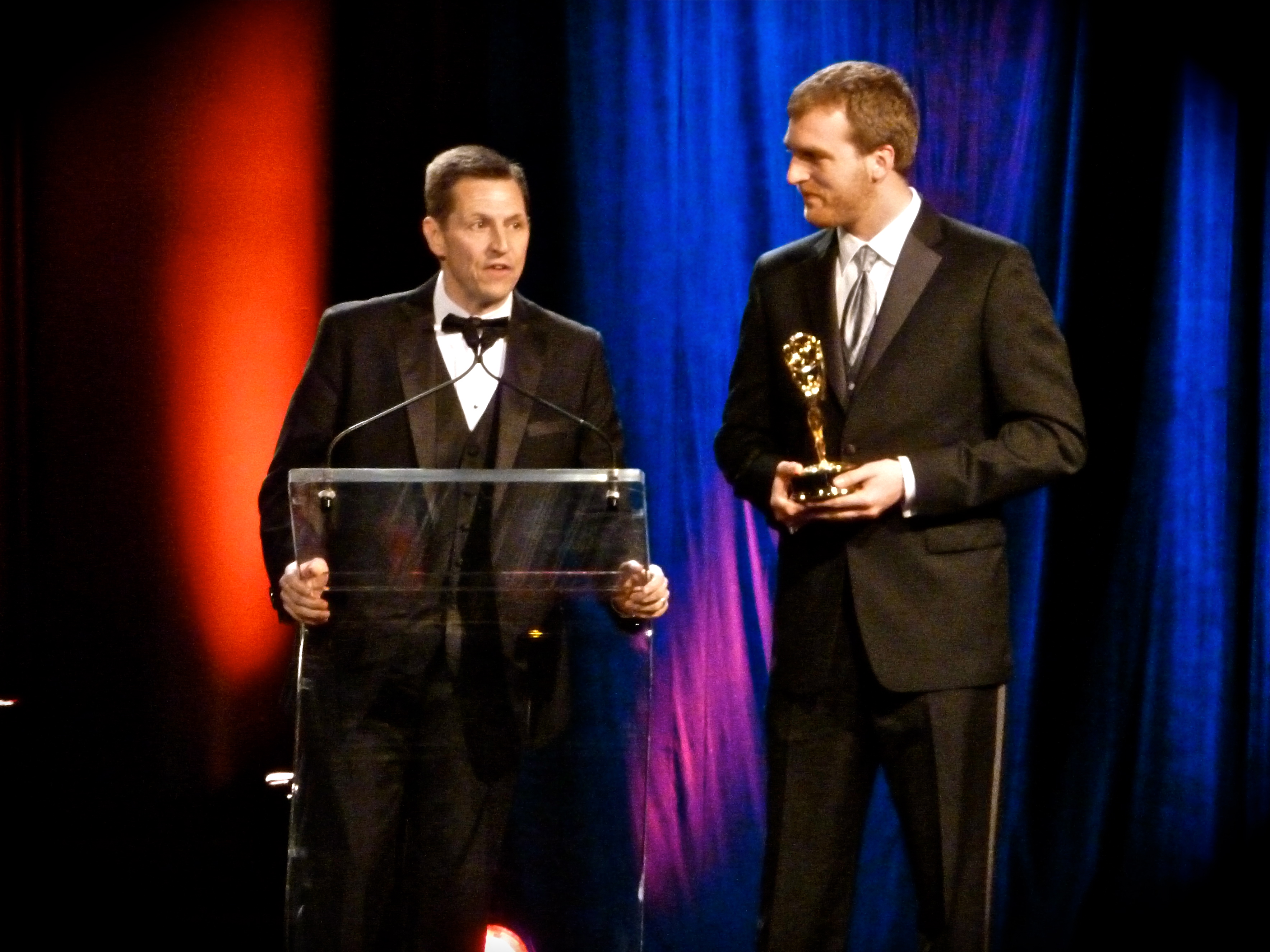Michael Wickham (right) accepts the Emmy Award along with Rich Becker for their feature story 